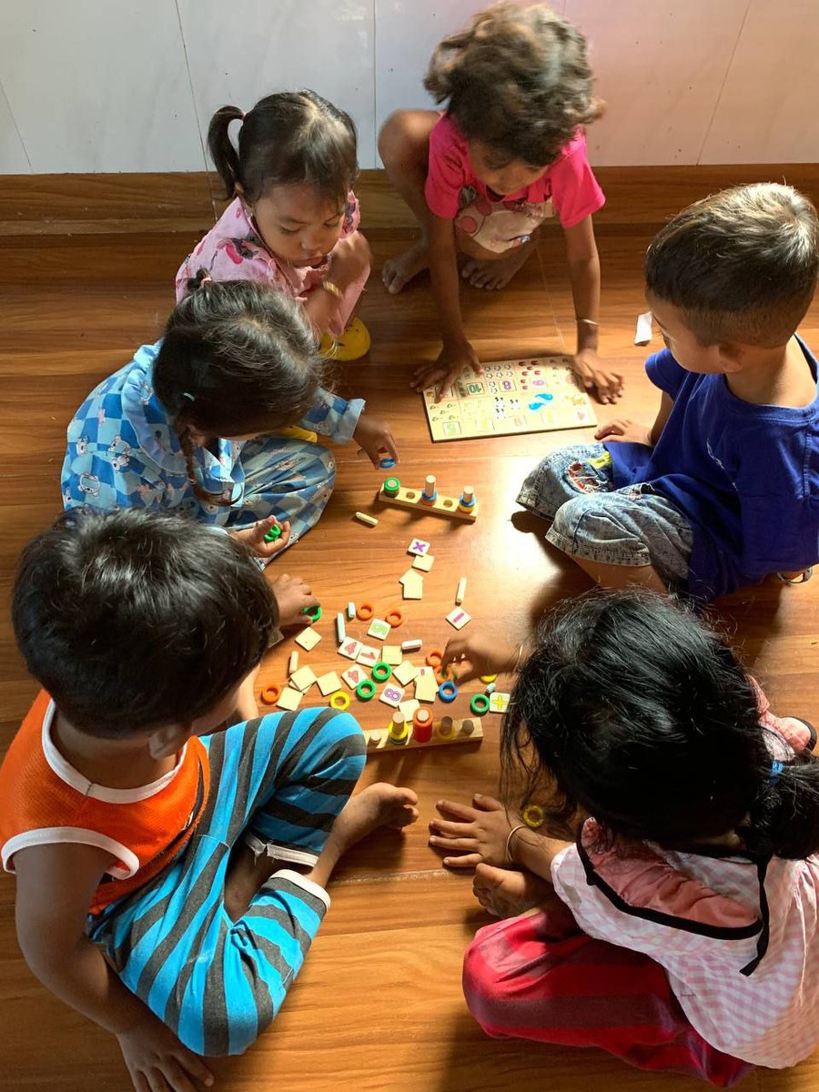 A teacher guiding children through an art activity at Chhuk Learning Centre