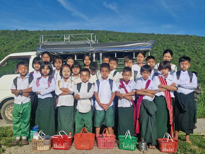 Grace Home students standing together by the van, ready for a trip