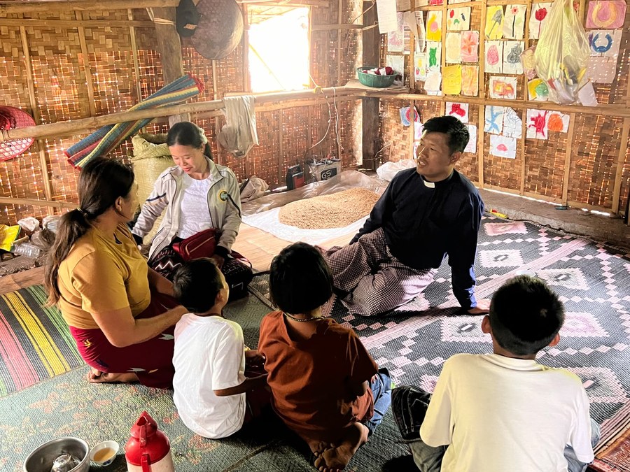 Praying with a patient during a hospital visit in Myanmar