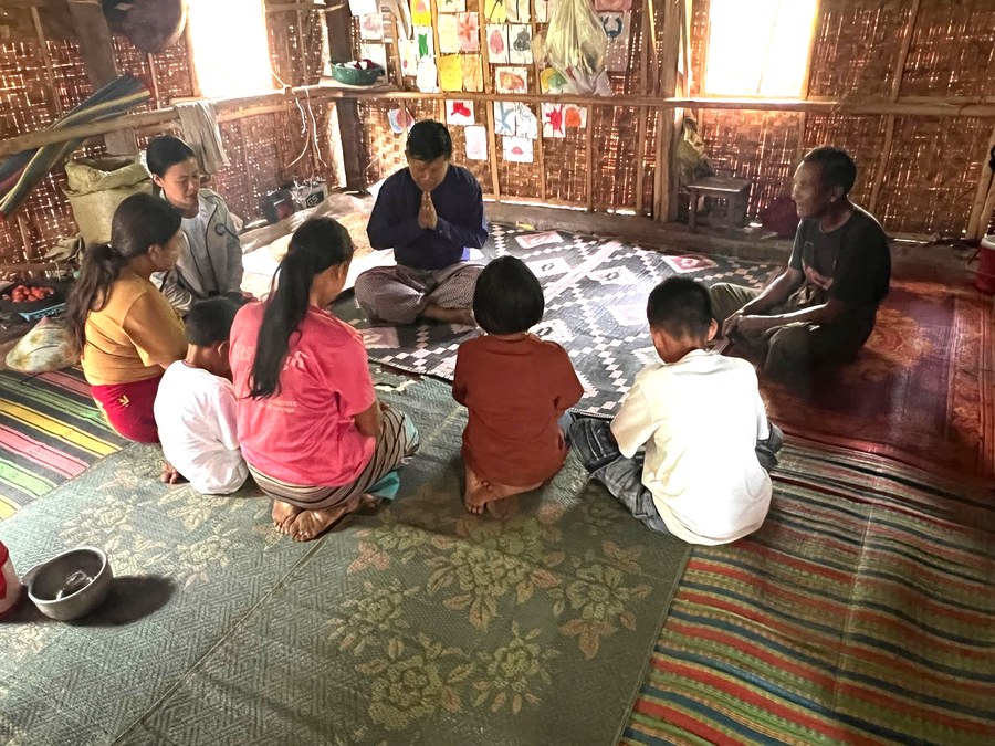 Praying together with a family in Myanmar