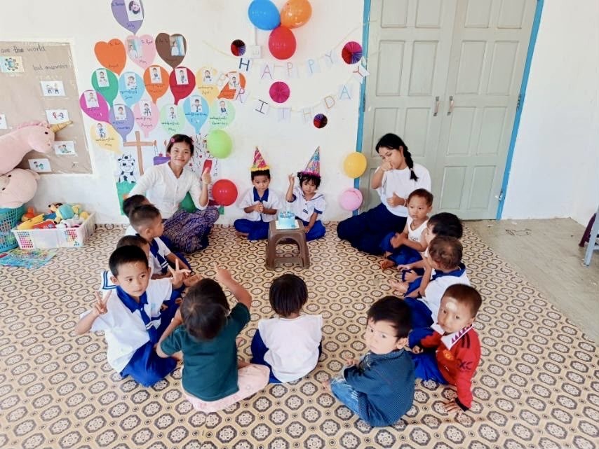 Teachers and children celebrating together at Joy Preschool